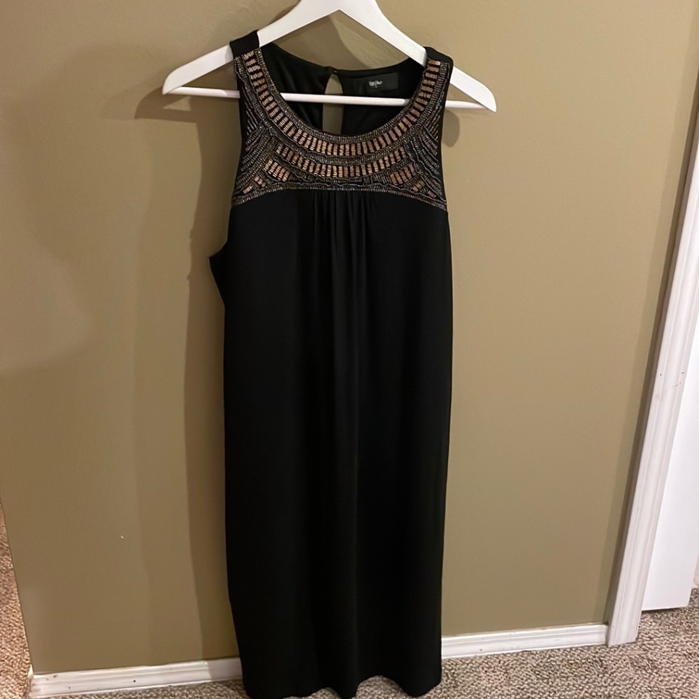 Great black dress with beaded neckline in gold tones.